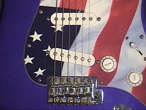 M. Rock's Fender Strat, a blue guitar
with an American flag pick guard